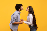 Young indian couple reaching each other with lips, ready to kiss over yellow ba, a Photo by Prostock-Studio (Thumbnail 3 of 4)