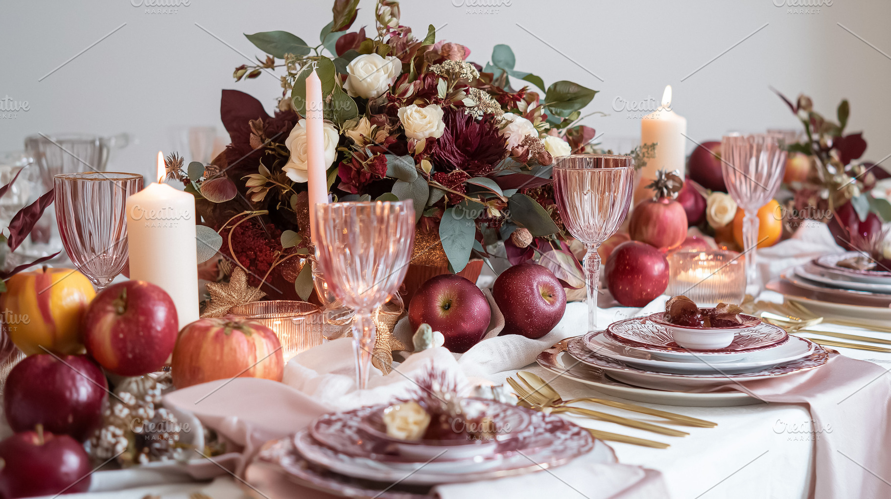 Elegant autumn tablescape with fresh apples and burning candles creating a warm, a Food & Drink Photo by Studio ANNA