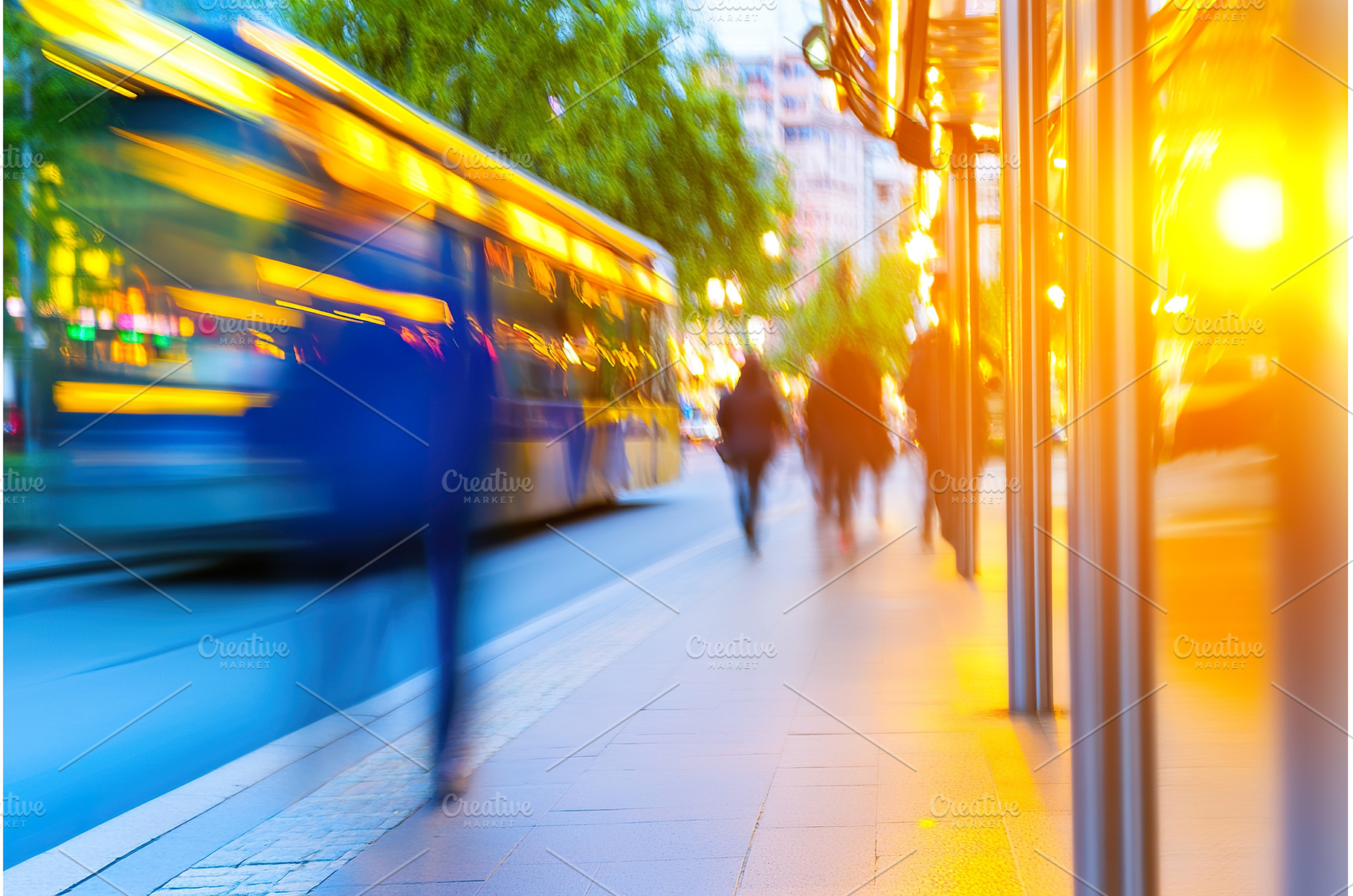 Blurred city street scene with bus, a Transportation Photo by Lermont51