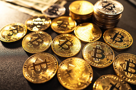 Bitcoin coins lined up in the background, a Business Photo by Art Rachen