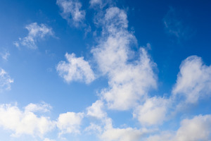 Blue sky with white cumulus clouds during a sunny day representi, a Photo by Studio ANNA