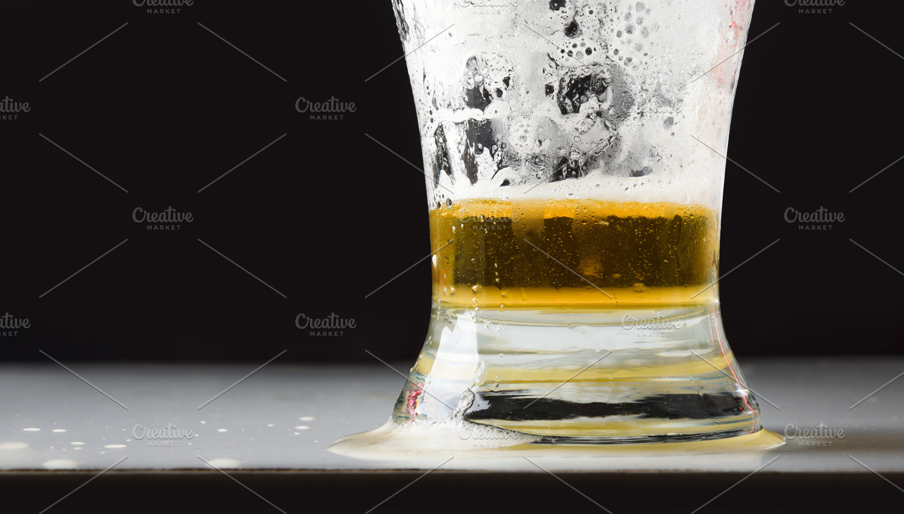 Detail of empty beer glass with foam isolated on black, a Food & Drink Photo by Davizro's Market