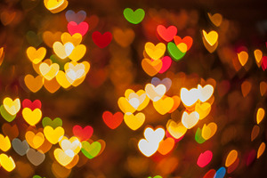 Heart background containing backlights, heart, and bokeh