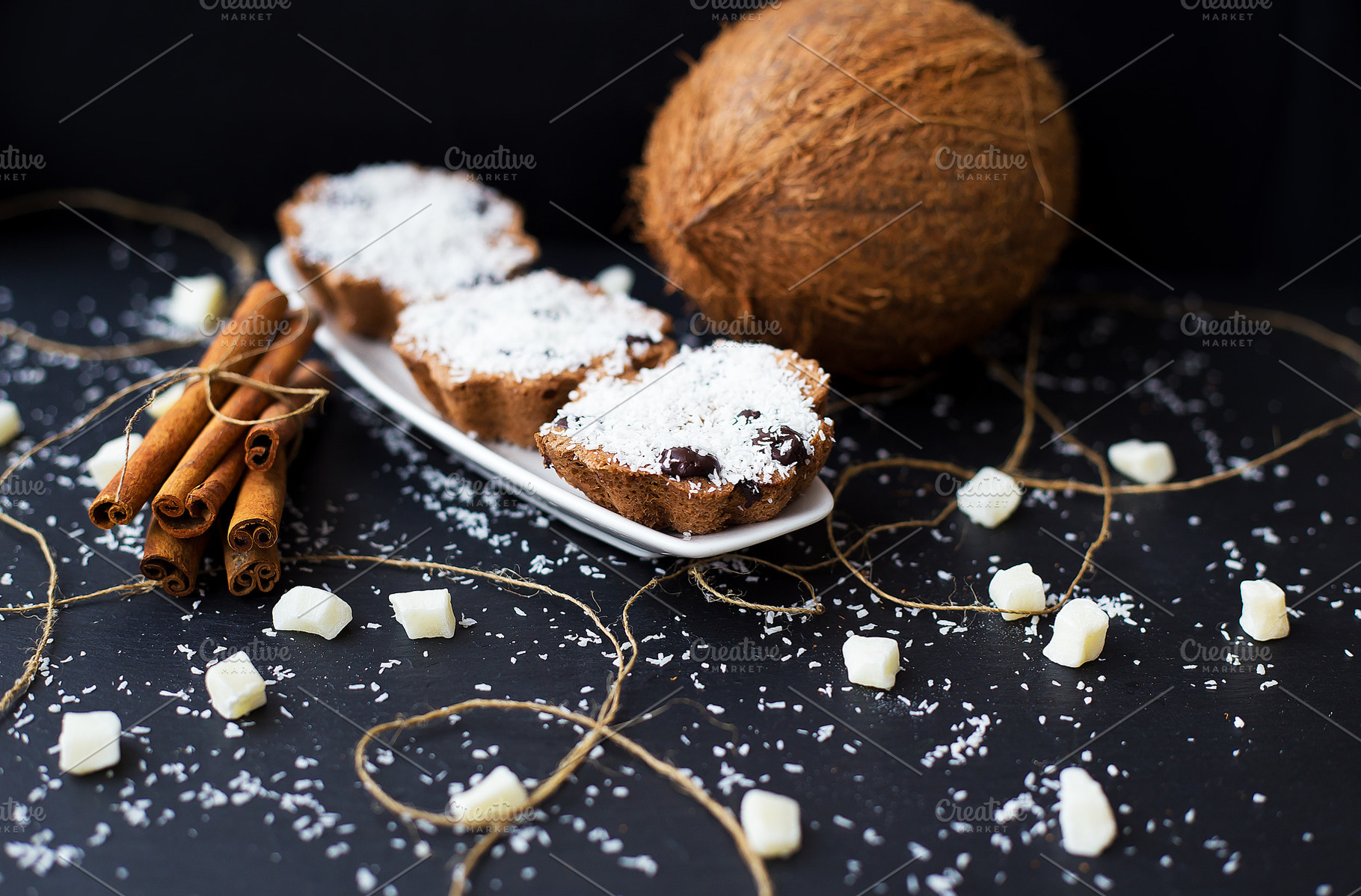 coconut muffins on a black background, a Food & Drink Photo by Artsaba Family