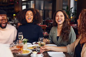 Friends laughing in restaurant