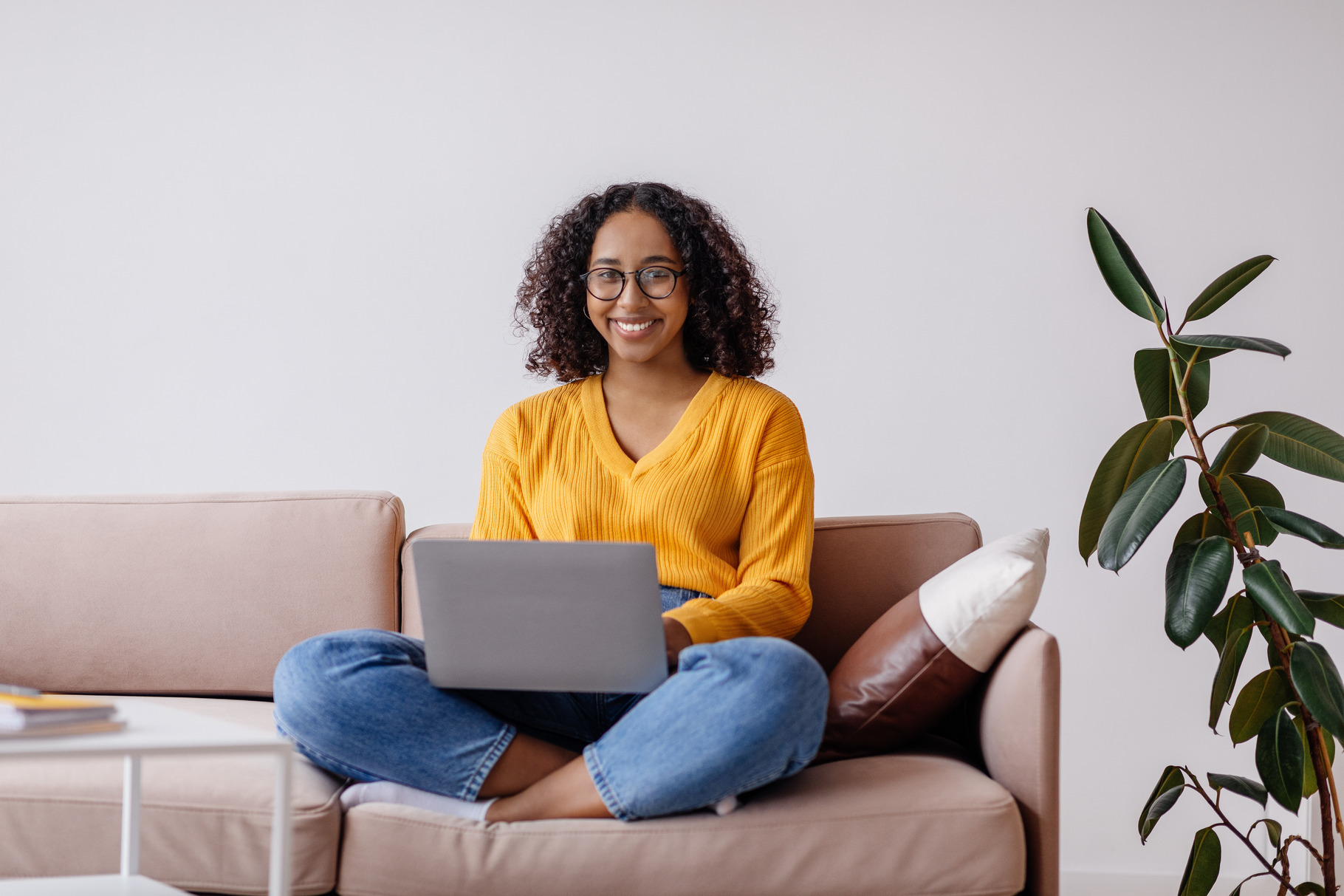Happy millennial black woman in glasses using laptop computer, sitting ...