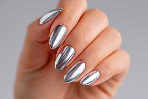 Close-up view of a perfectly manicured female hand with metallic silver nails o, a Beauty & Fashion Photo by AlyaAnd
