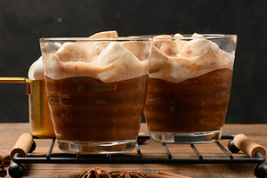 Hot chocolate with fluffy marshmallows on a wooden board., a Food & Drink Photo by ndanko