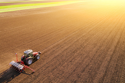 Aerial shot of a farmer sowing crops, an Industrial Photo by oticki