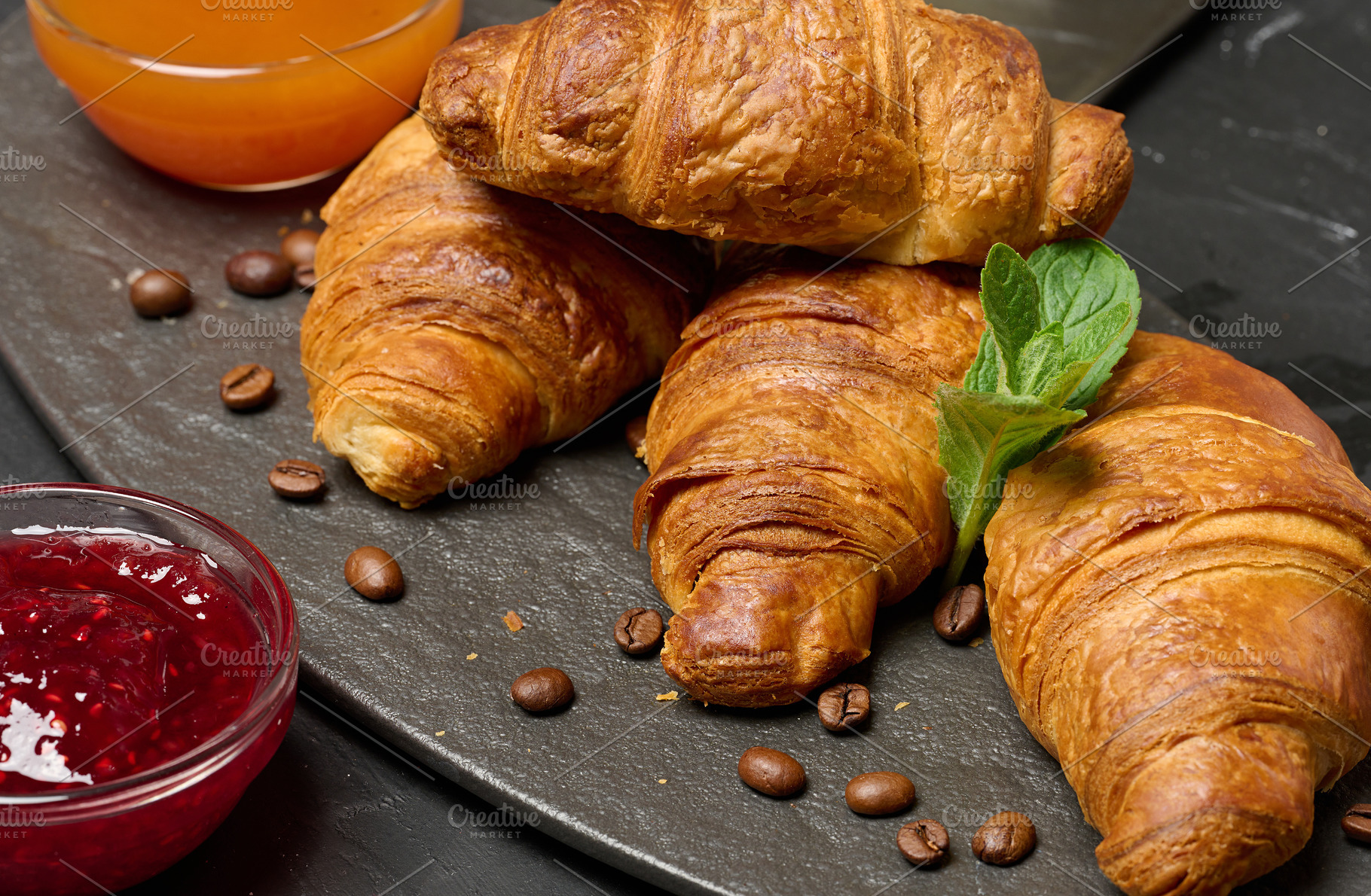 Baked croissant on black board, delicious breakfast,, a Food & Drink Photo by ndanko