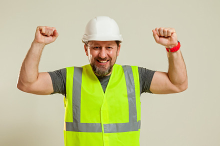 worker in a vest and white helmet, a Person Photo by Photostock