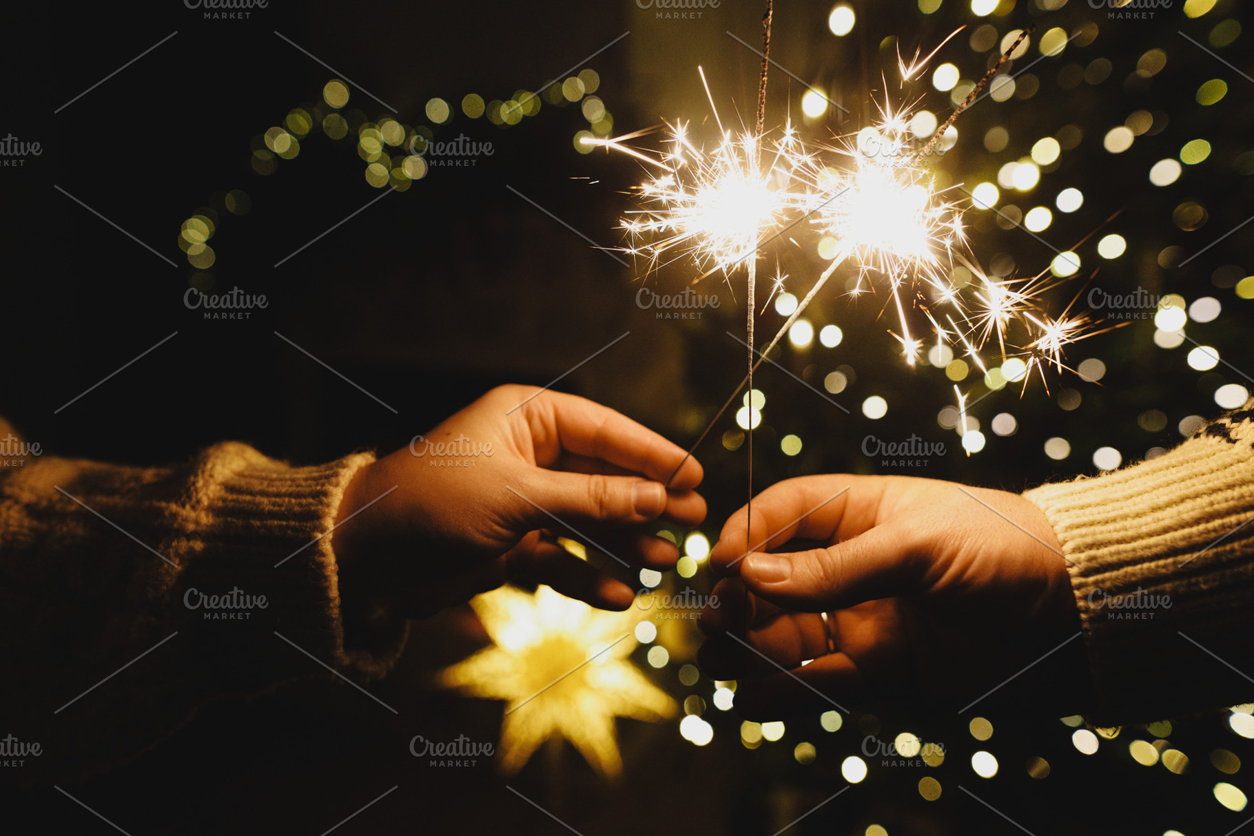 Happy New Year! Burning sparklers in hands on background of chri, a Holiday Photo by Sonjachni