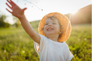 Cute girl playing on meadow, in, a Person Photo by HalfPoint