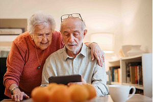 Elderly couple enjoying technology, a Technology Photo by HalfPoint