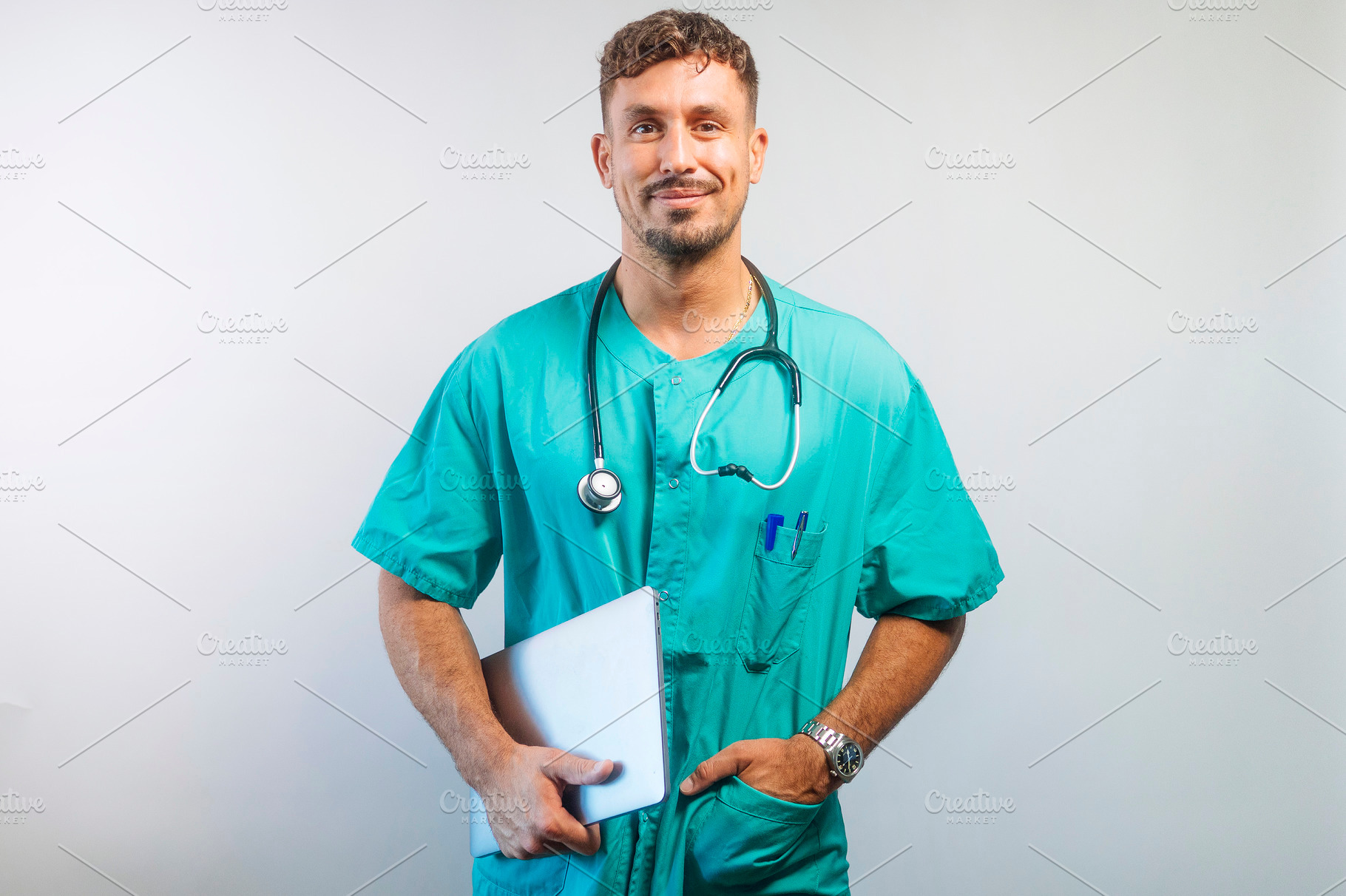 Doctor Holding Laptop with a Smile, a Person Photo by karrastock