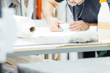 Male worker cutting the leather patt