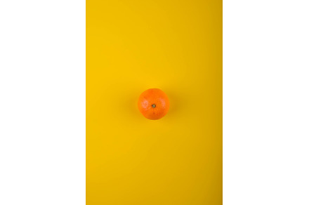 Ripe orange on yellow background., a Food & Drink Photo by Yulia Furman