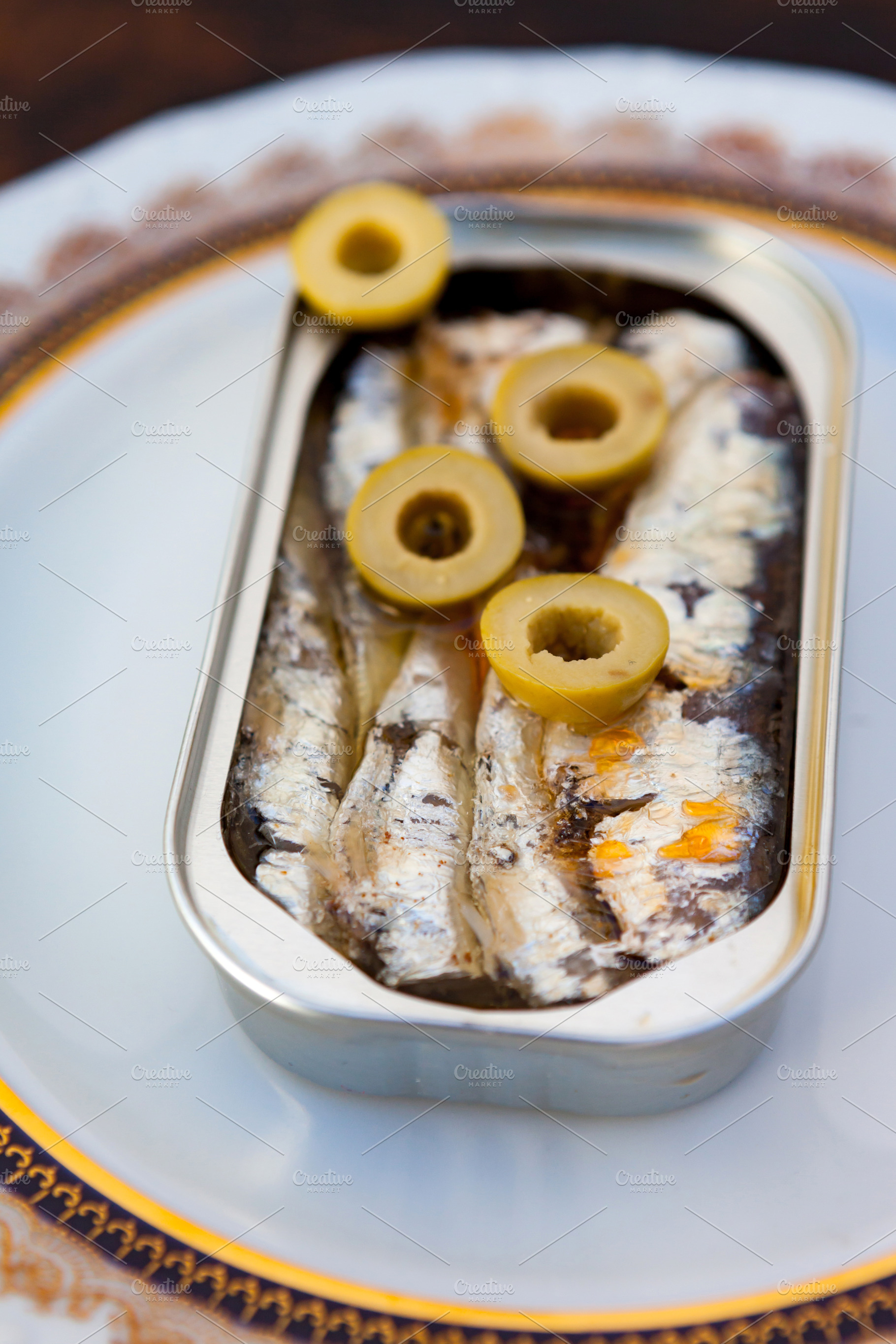 Can of canned oil sardines on a elegant plate, a Food & Drink Photo by José Manuel Gelpi