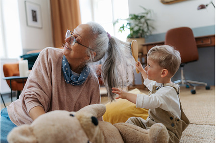 Little boy combing his grandomther, a Person Photo by HalfPoint
