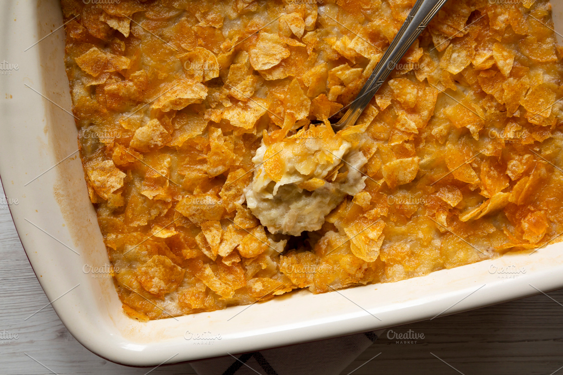 Cheesy Homemade Funeral Potatoes Casserole in a dish, top view., a Food & Drink Photo by LiudmylaChuhunova