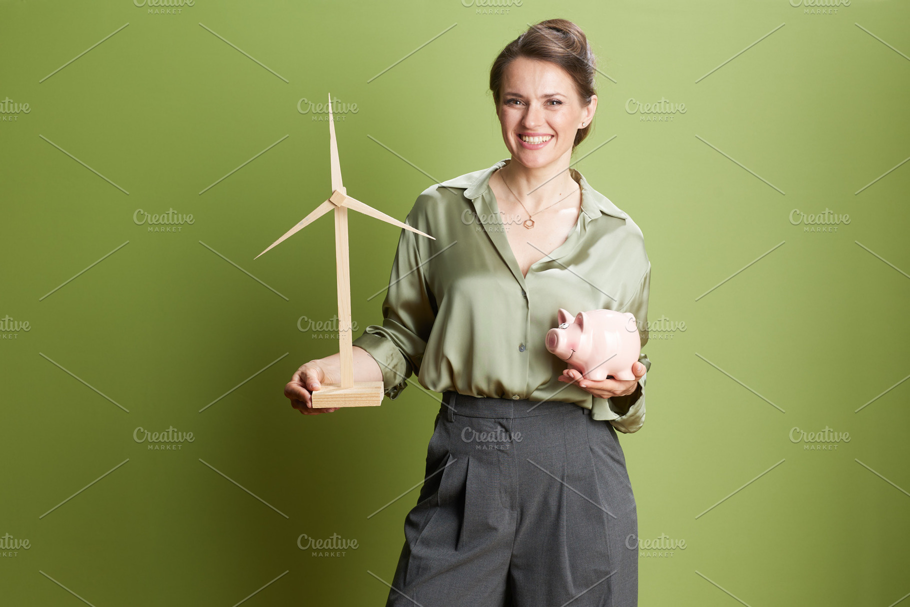 Green Investment: Woman & Wind Turbine Model, a Person Photo by Alliance Images