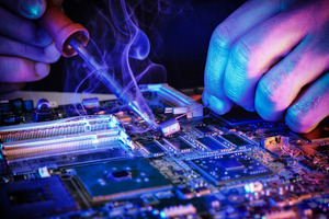 Technician Repairing Laptop Motherboard with Soldering Iron, a Technology Photo by Davizro's Market