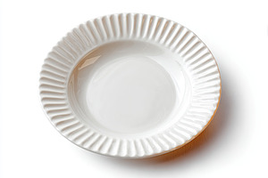 Elegant ceramic plate with ridged edge design for dining or display, a Photo by AlyaAnd