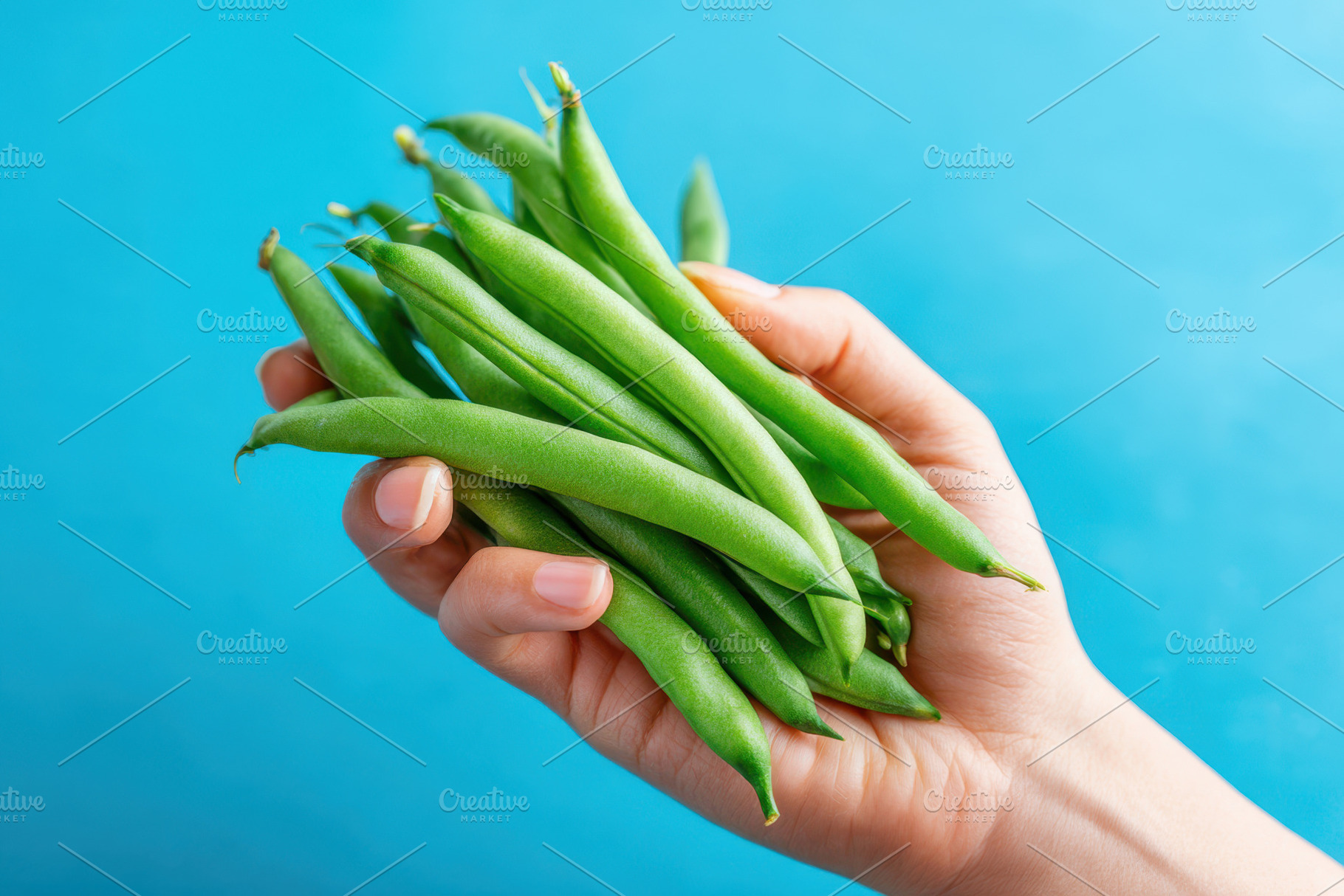 Hand holding fresh green beans, a Food & Drink Photo by AlyaAnd