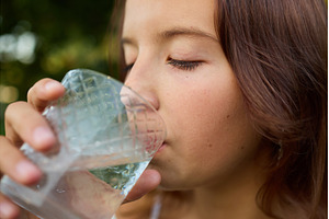 Girl drinks clear water from glass, a Nature Photo by IlliaBondarPhotography