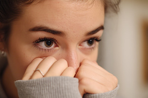 Anxious young woman covering her, a Person Photo by MistyDay