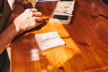 People eat cheese and drink wine in