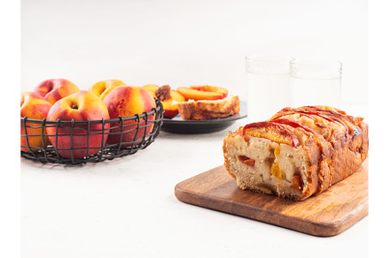 Peach cake loaf on wooden cutting