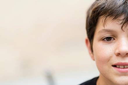close up and portrait of teenager or boy smiling and looking at the camera, a Person Photo by RF Images