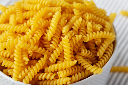 Raw Dry Organic Rotini Pasta Ready to Cook, low angle view. Clos, a Food & Drink Photo by LiudmylaChuhunova