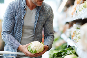 Healthy man choosing cauliflower, a Food & Drink Photo by MistyDay