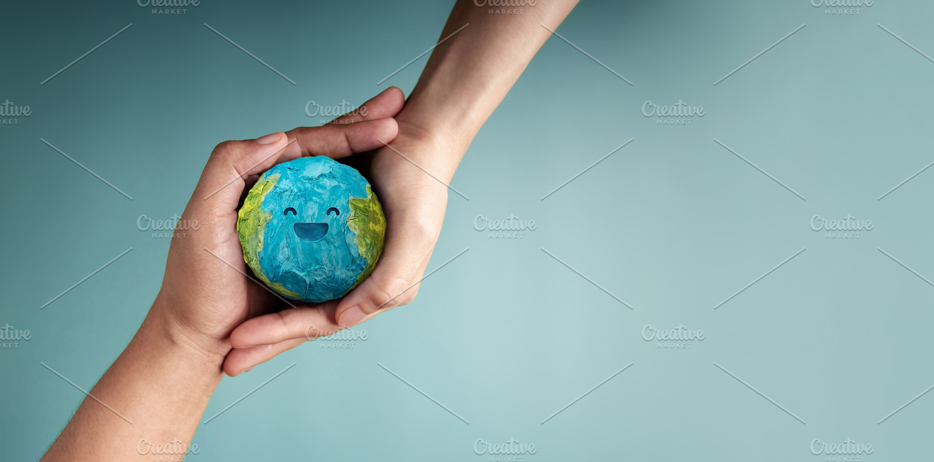 two people holding Happy Smiling Earth symbolizing sustainabilit, a Photo by salmon.black