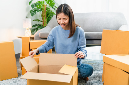 Young Asian woman pack the product and send to the customer.