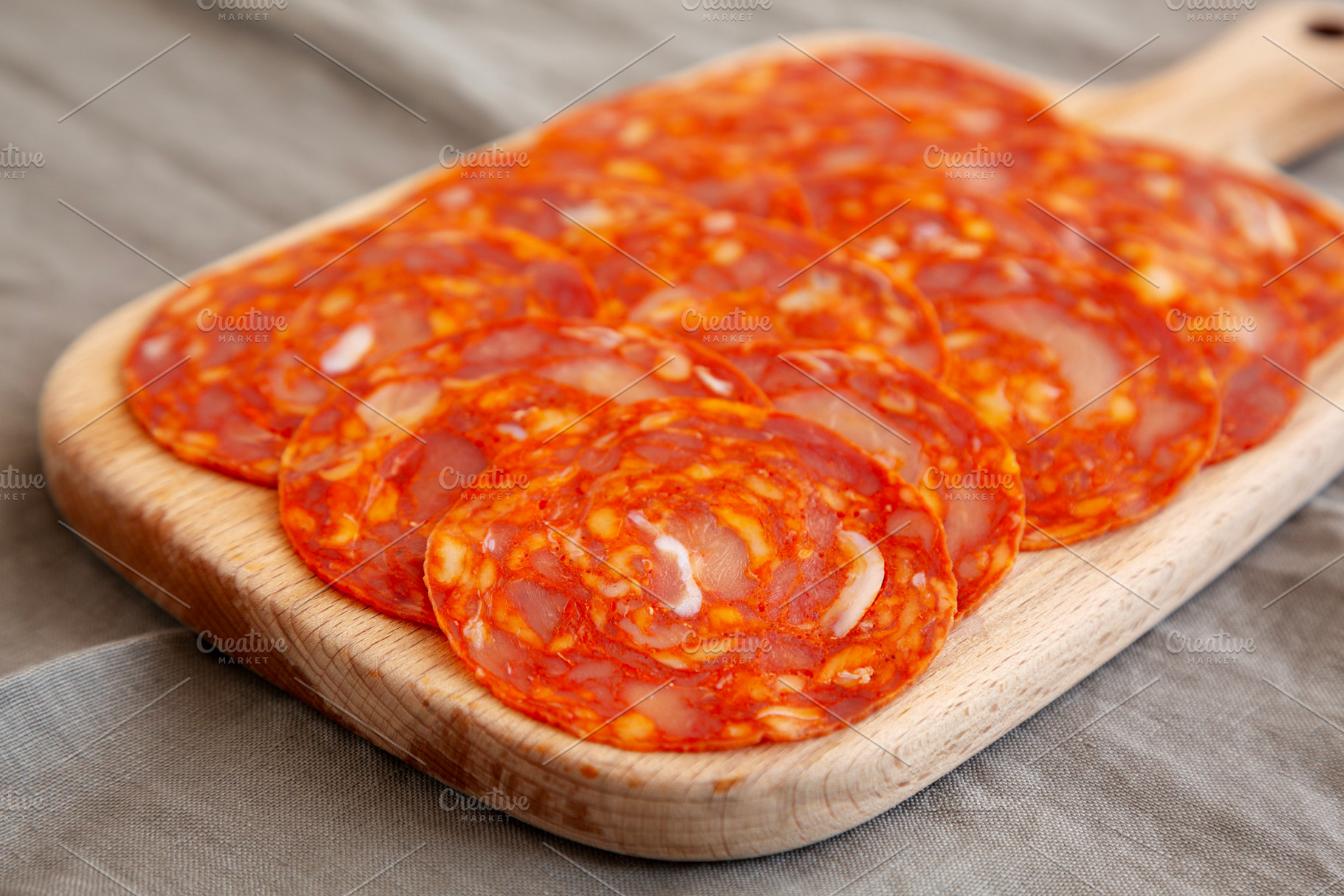 Cold Meat Chorizo Slices on a Wooden Board, side view. Close-up., a Food & Drink Photo by LiudmylaChuhunova