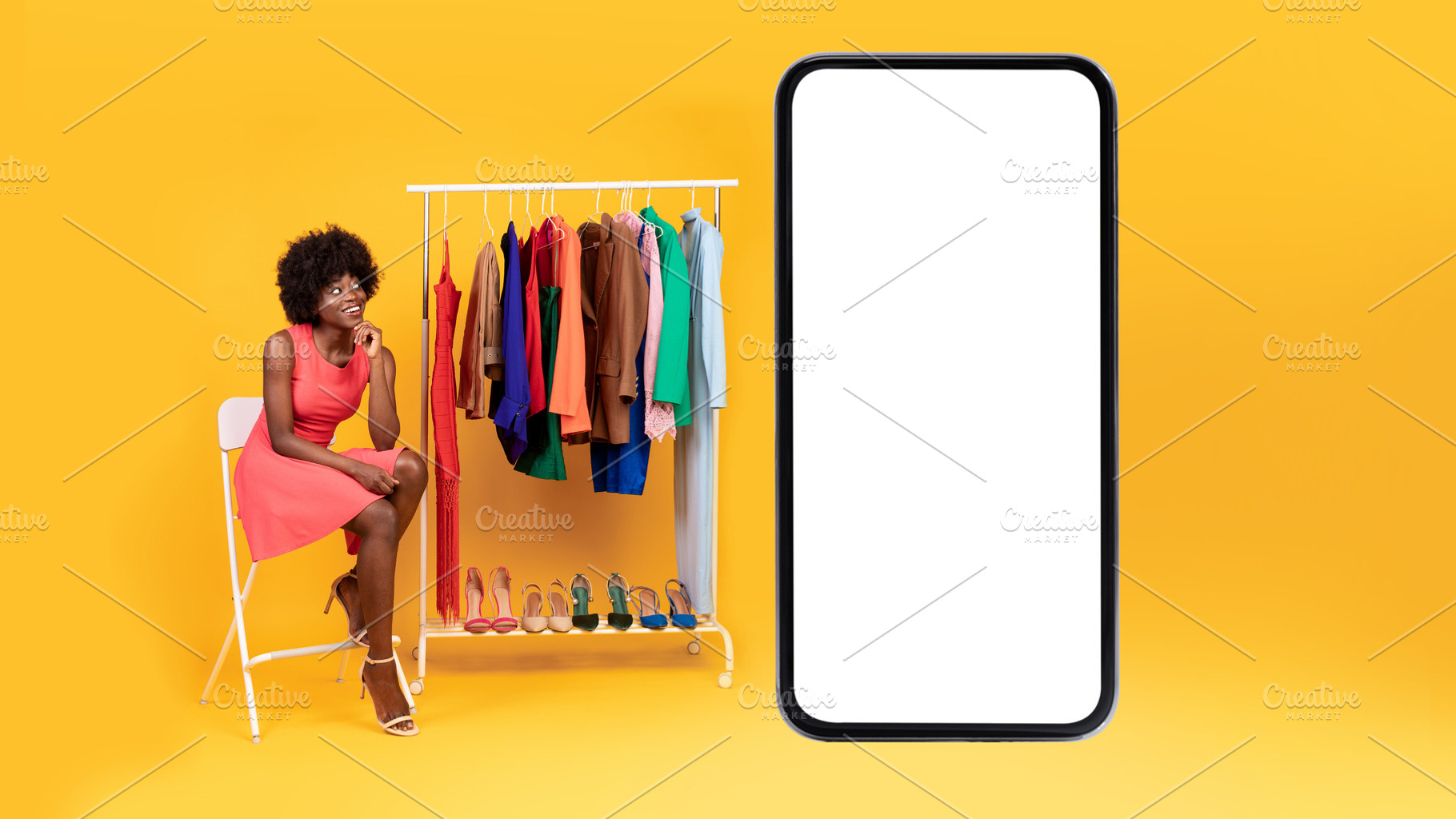 Black Woman Sitting Near Cellphone And Clothing Rack, Yellow Background, a Photo by Prostock-Studio