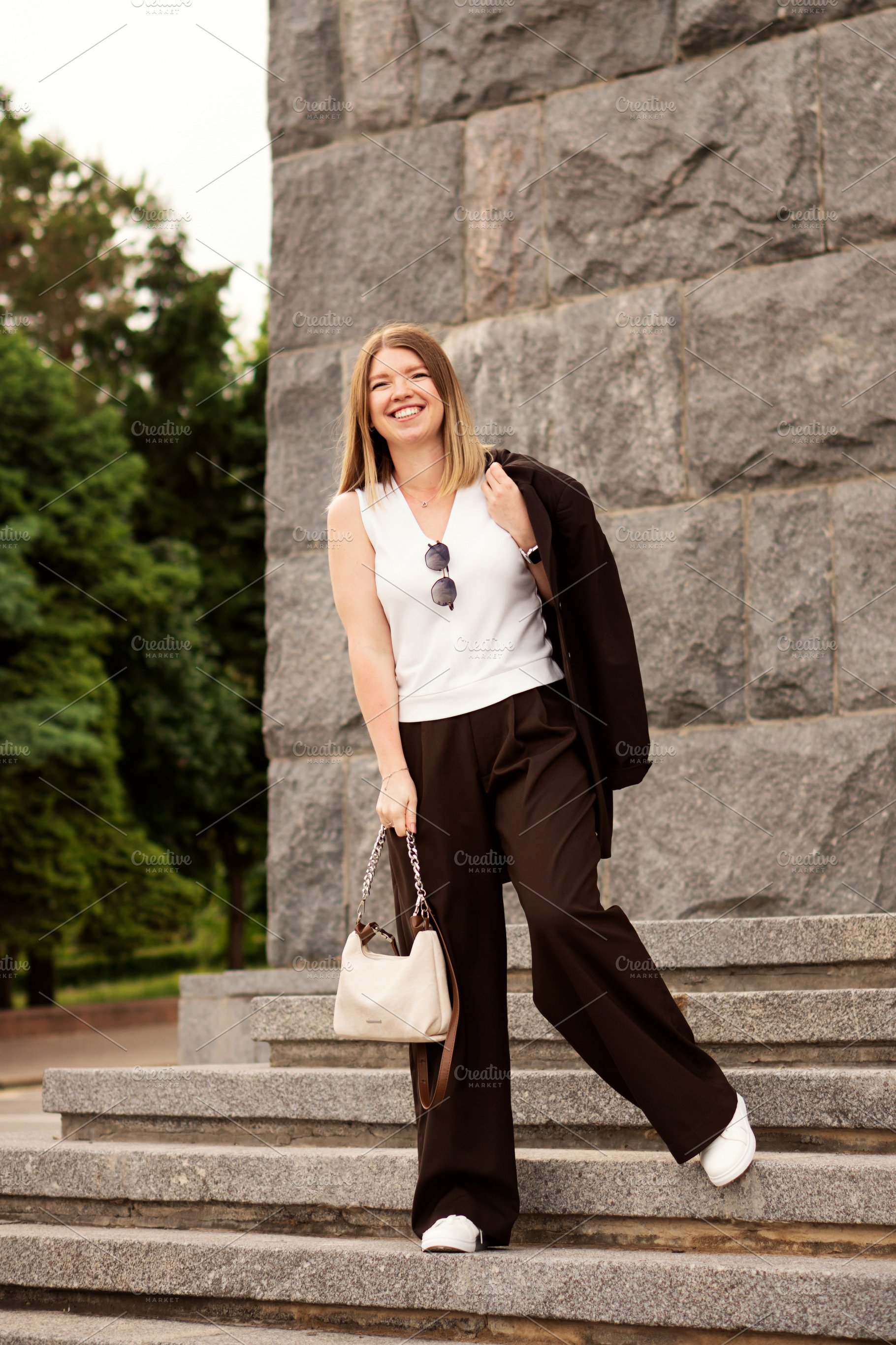 Young woman smiling confidently, a Person Photo by Elena Vagengeim