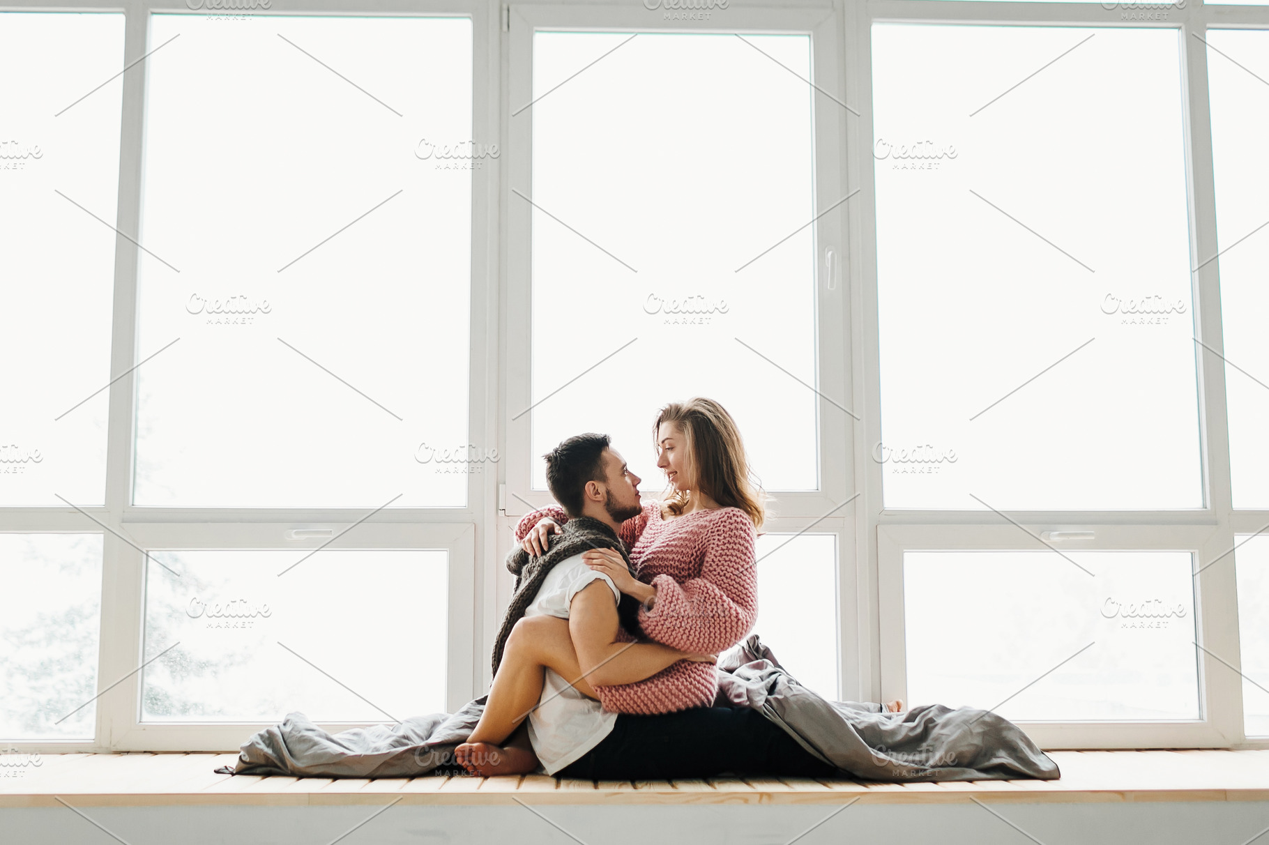 A couple in love sits on the windowsill. Newlyweds having fun., a Person Photo by Stahov