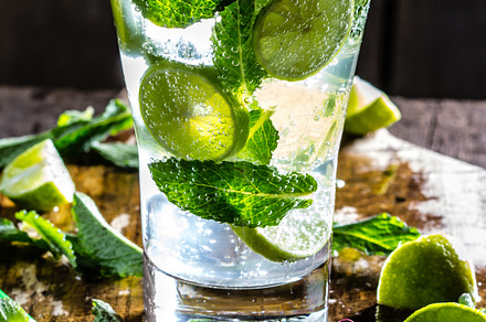 Mojito cocktail with lime and mint on wooden rustic background stock photo, a Food & Drink Photo by LARISA BLINOVA