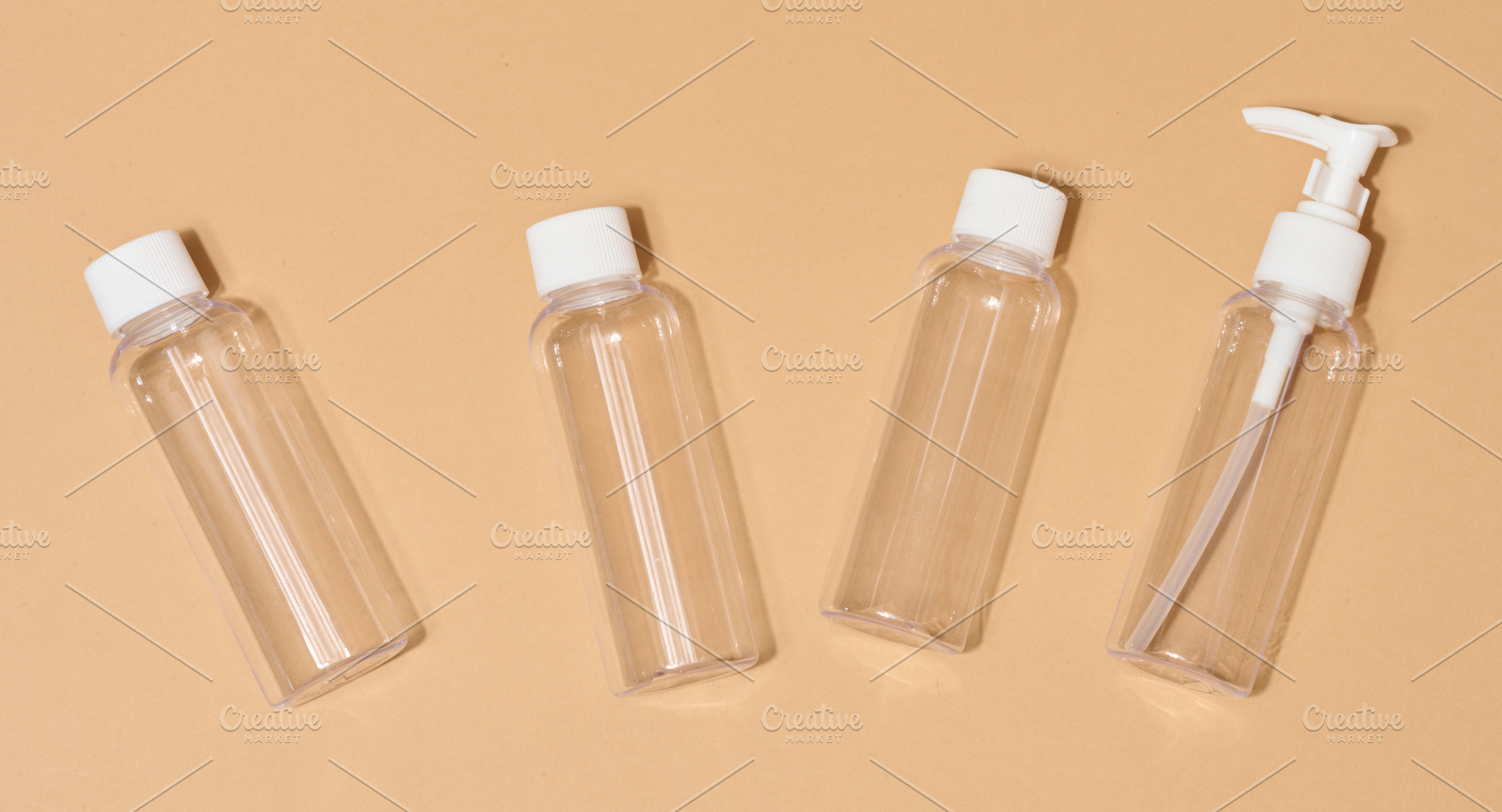 Travel set of plastic bottles for cosmetics on beige background, a Health & Medical Photo by ndanko