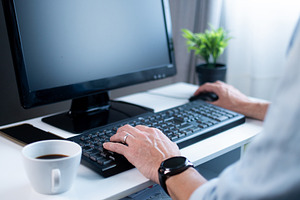 Close up of man typing on keyboard while working from home, a Person Photo by etorres69