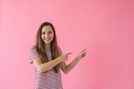 Girl shows on empty space containing woman, hand, and female