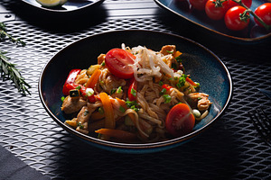 Noodles with Chicken and Vegetables on Dark Plate on Black Table, a Photo by MDBildes
