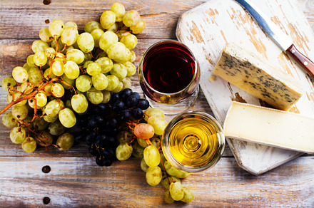 Red and white wine and assortment of cheese containing food, drink, and, a Food & Drink Photo by Ekaterina_Markelova