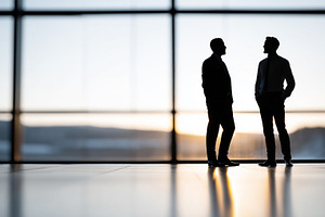 Silhouette of two businessmen talk, a Business Photo by MistyDay