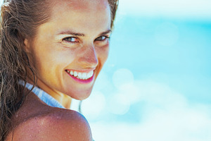 smiling young woman on beach, a Person Photo by Alliance Images