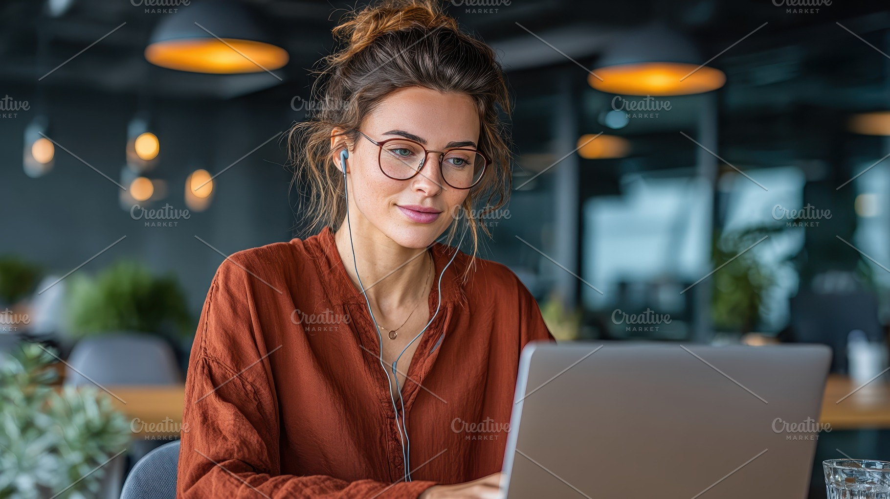 Woman works on laptop in modern offi, a Photo by Pixeness Studio